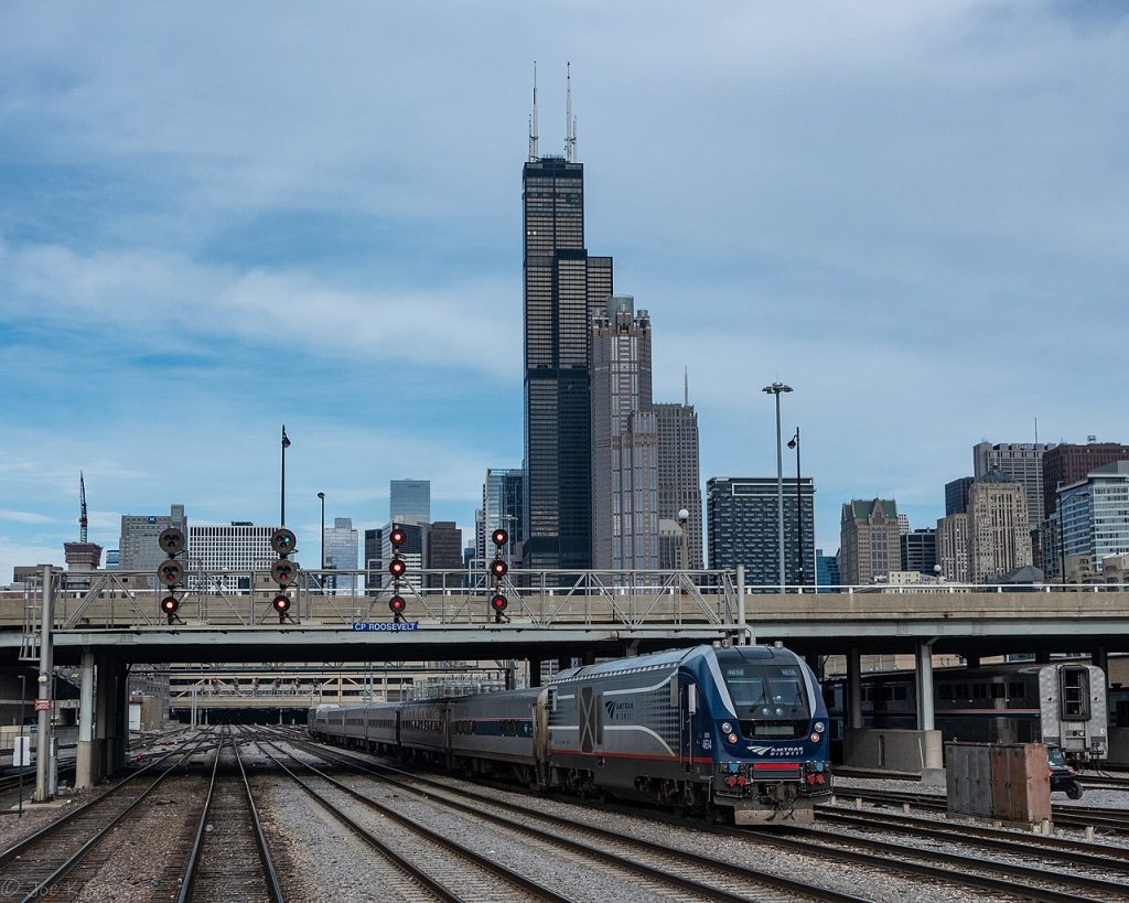 Train from Michigan arriving downtown Chicago with Sears, Willis Tower in the background.